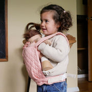 A qulited rose Olli Ella Doll Carrier with padded straps designed for carrying dolls.